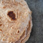 close up view of whole wheat sourdough tortillas on a concrete countertop