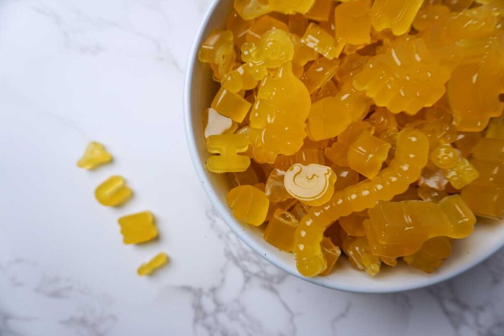 Homemade three ingredient fruit gummies in a large white bowl