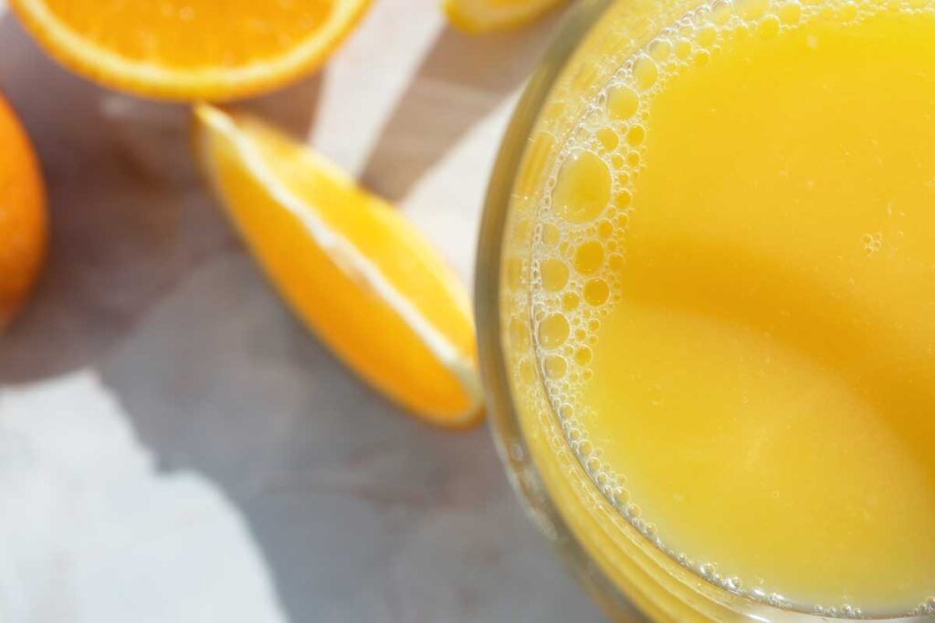 close up view of top of glass with fresh orange juice