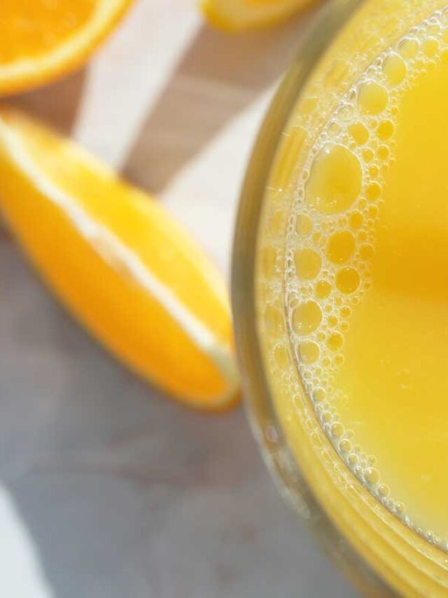 homemade gatorade in a glass with orange slices on the countertop