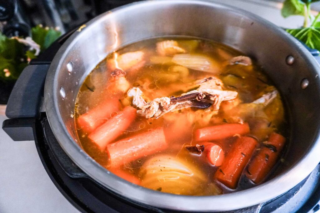 homemade bone broth simmering in an instant pot