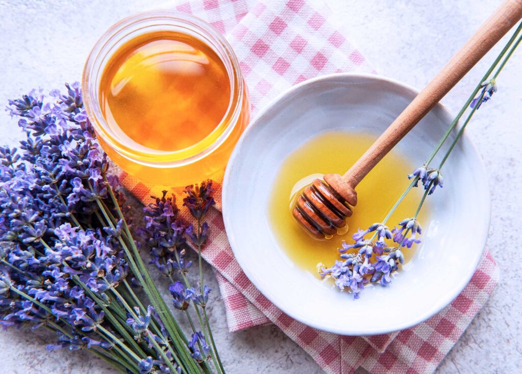 honey in a bowl with fresh lavender
