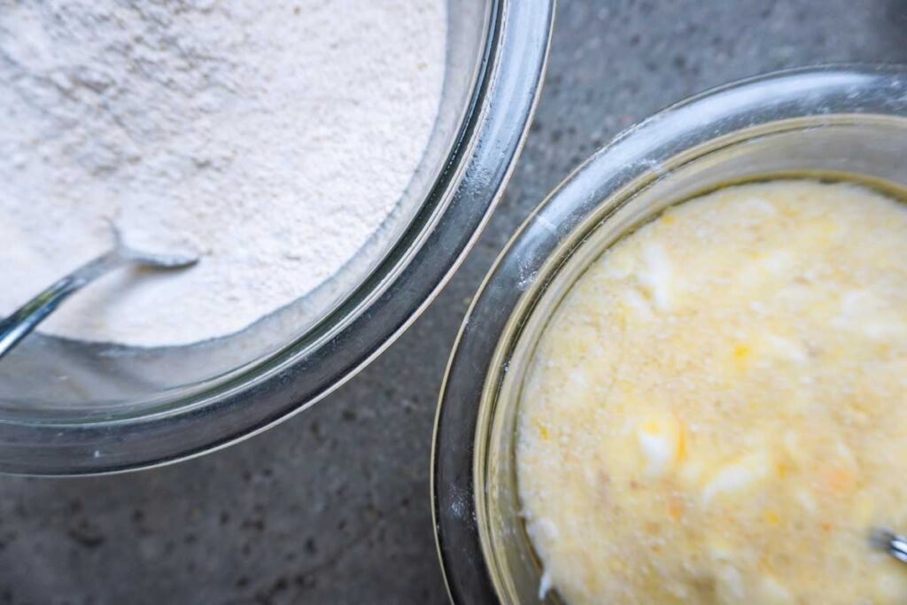 Two bowls of wet and dry ingredients to make muffins