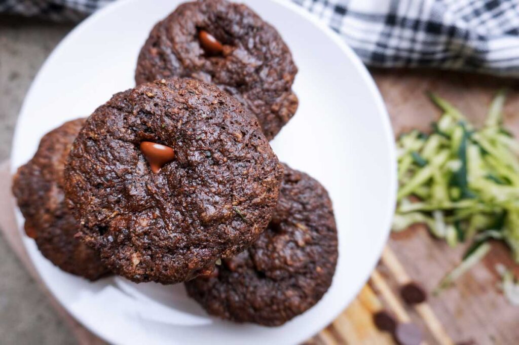 Close up view of chocolate zucchini muffins with fresh milled flour on a white plate