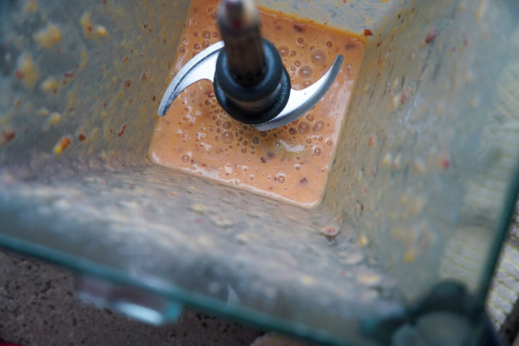 Looking into a blender making peach ice cream