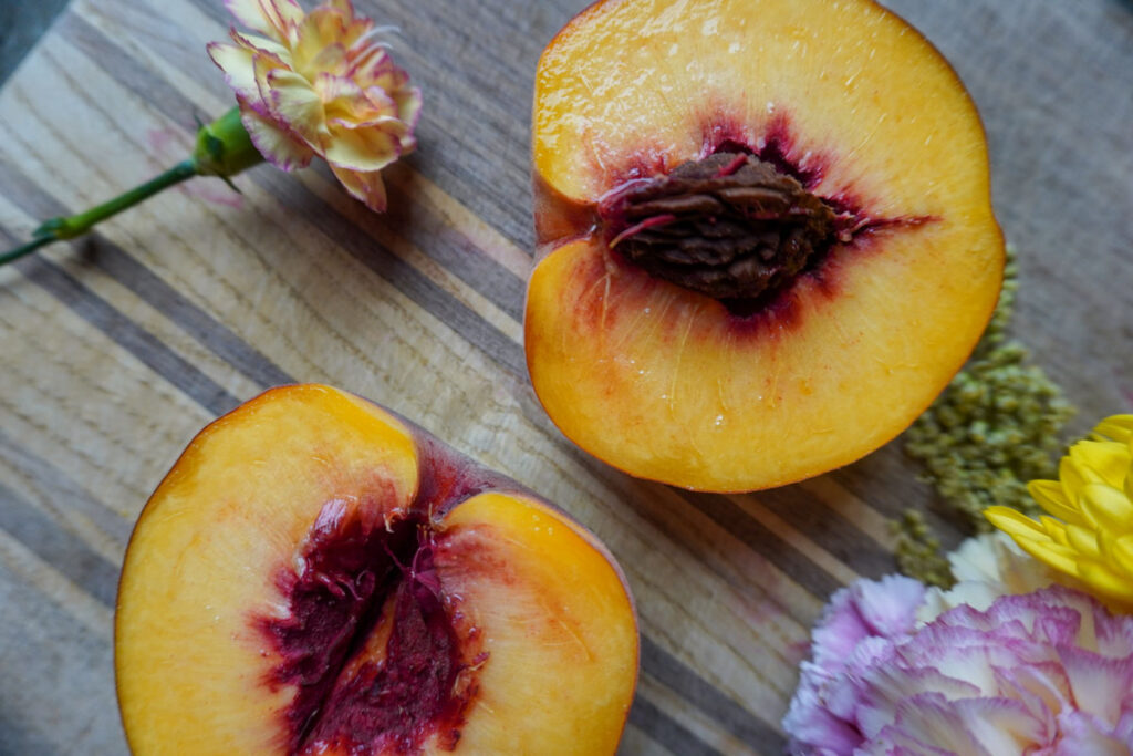 Fresh peach cut in half. 