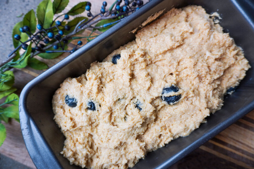 fresh lemon blueberry quick bread batter in a loaf pan
