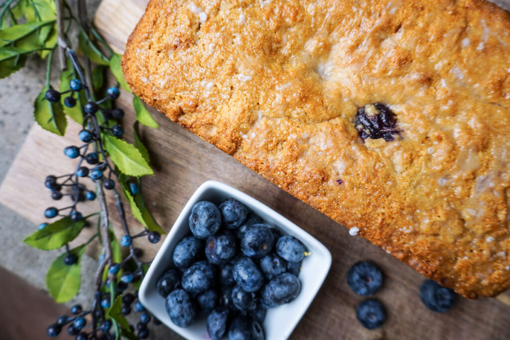 Freshly baked healthy lemon blueberry bread on a cutting board