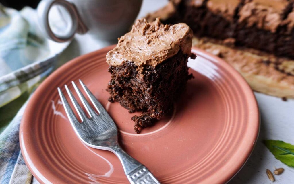 Side view of a whole wheat chocolate brownie with frosting.