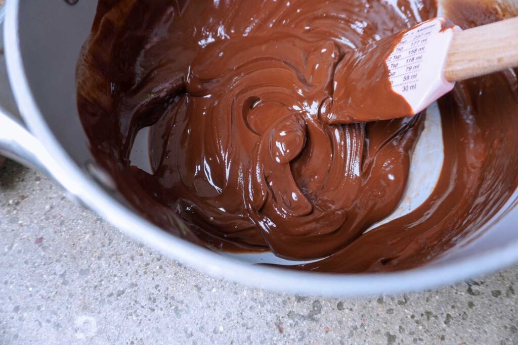 Pan of melted chocolate with a spatula.