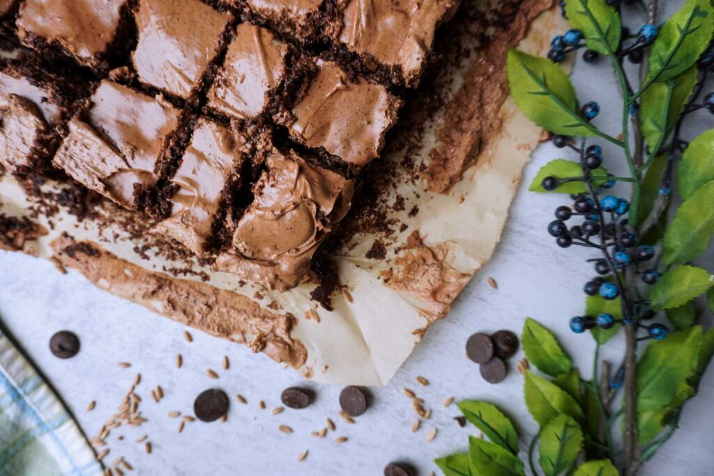 Top view of freshly cut fudgy brownies with frosting