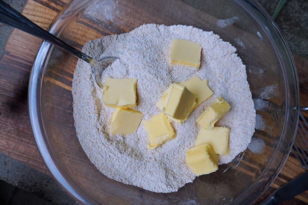 Bowl of fresh milled flower with chunks of butter inside