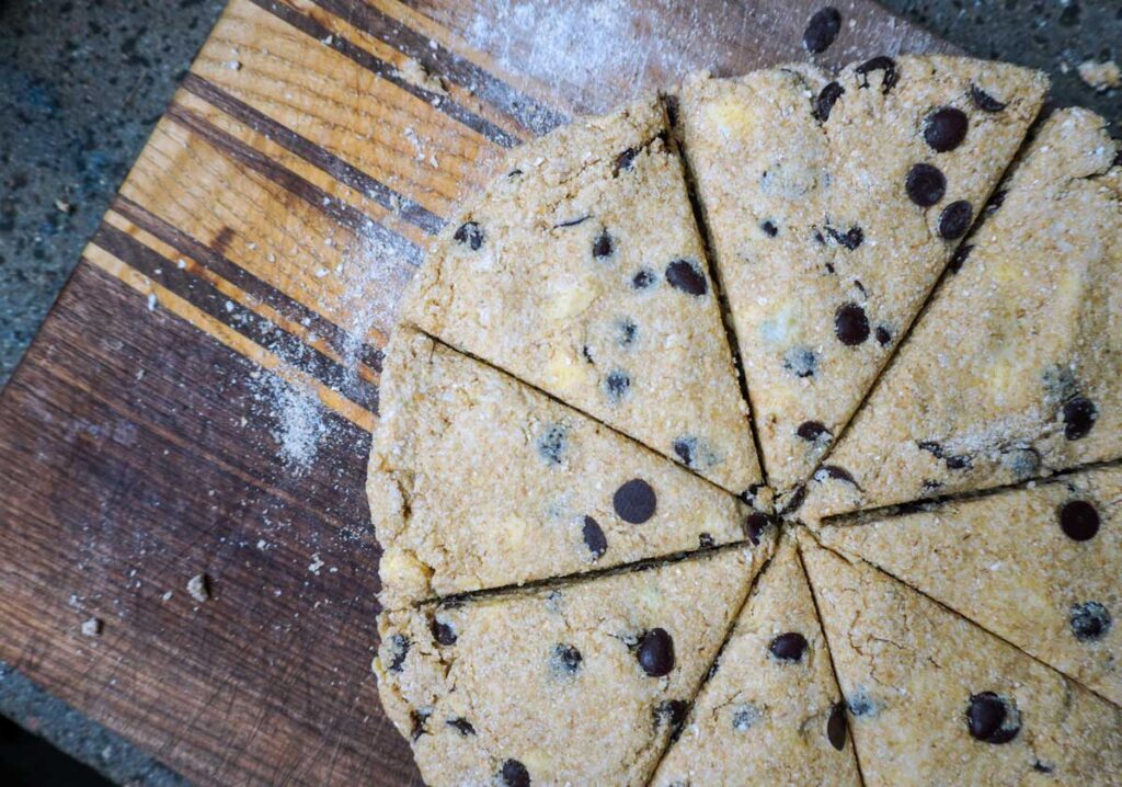 Top view of scones cut into wedges on a cutting board.