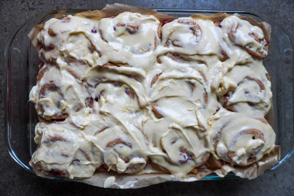Tray of freshly baked rolls with lemon and raspberries