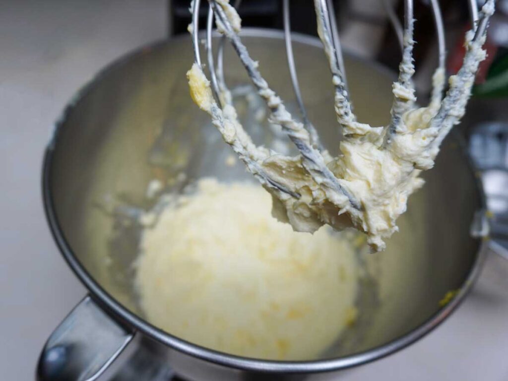 Homemade lemon cream cheese frosting in a kitchen aid mixer.